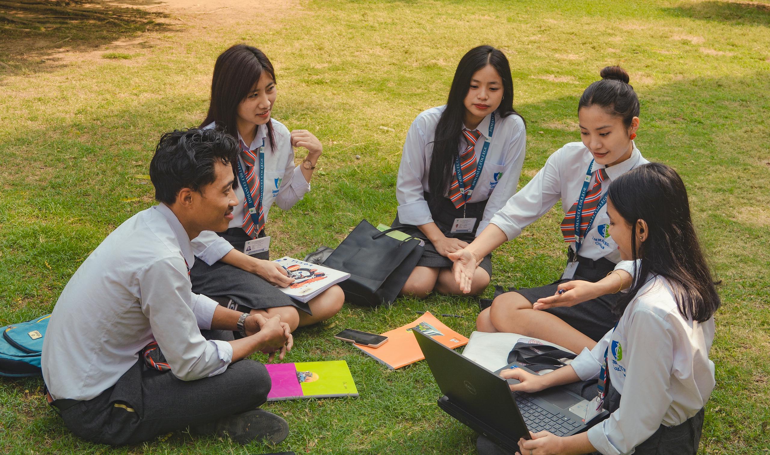 A group of college students studying together on a sunny day in Dimapur, India.